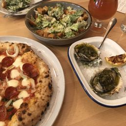 Caesar salad, carne pizza grilled oysters with chimichurri sauce and kombucha drink