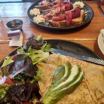 Geppetto Cafe - Savory crepe with side salad in the front and classic Challah French toast with strawberries in the rear - Coffee & Tea Near Me - Pittsburgh, Pennsylvania