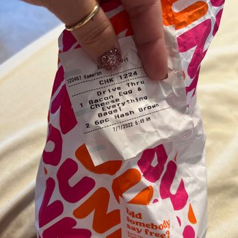 Dunkin' - a hand holding a bag of donuts - Coffee & Tea Near Me - Cornelius, North Carolina Dunkin' - a hand holding a bag of donuts - Coffee & Tea Near Me - Cornelius, North Carolina