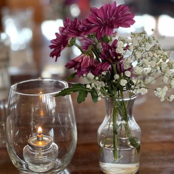 Summit House Restaurant - a vase of flowers and a candle - American Near Me - Enumclaw, Washington