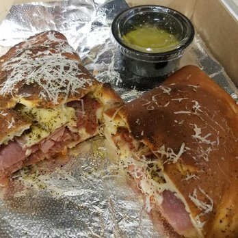 Sauce on the Side - The Carmen. Prosciutto, Capicola, spinach, parmesam, fontana, ricotta, garlic oil. Garlic butter on the side. - Italian Near Me - Clayton, Missouri