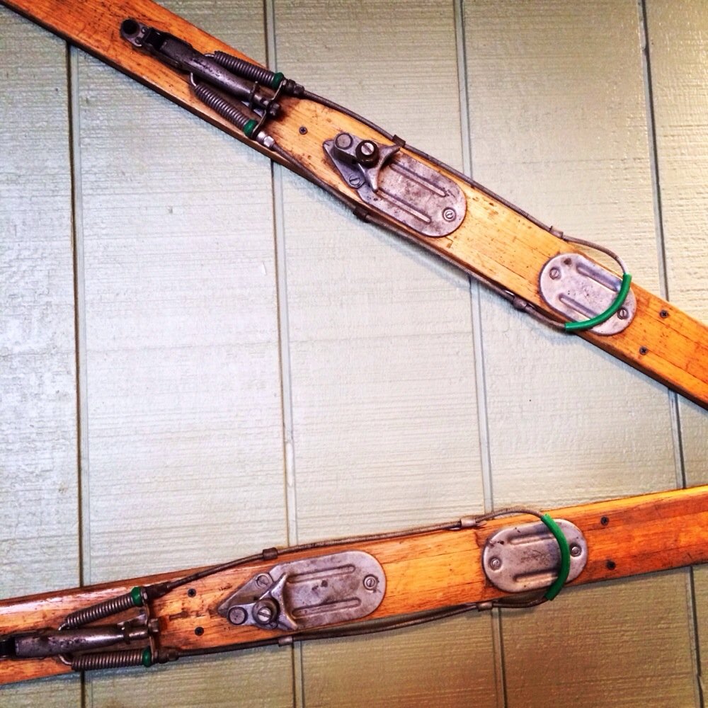 a pair of skis on a wooden floor a pair of skis on a wooden floor
