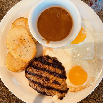 Liliha Bakery - Two egg breakfast with meat patty perfectly done and potatoes sub for rice.  Gravy was delicious! - Bakeries Near Me - Honolulu, Hawaii