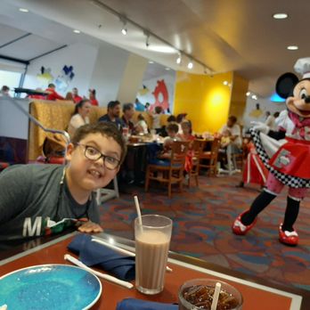 Chef Mickey's - Kiddo had to lean way over to get in the photo with Minnie. I asked, but she refused to move a little to her right, even shaking her head no - American Near Me - Lake Buena Vista, Florida Chef Mickey's - Kiddo had to lean way over to get in the photo with Minnie. I asked, but she refused to move a little to her right, even shaking her head no - American Near Me - Lake Buena Vista, Florida