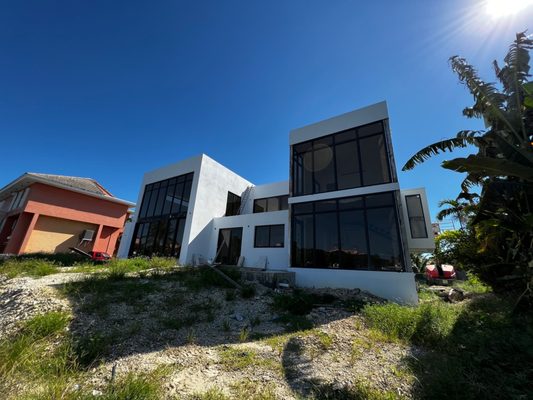 Impact Window Installation - Impact windows and doors provide protection against the strong winds of hurricanes or severe local storms, as they are made of laminated glass resistant to high impact forces.
