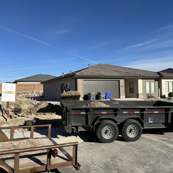 Axis One Construction - a dump truck parked in front of a house - General Contractors Near Me