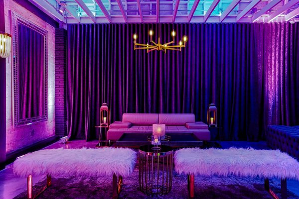 Indoor Lounge - Our upscale urban lounge is fully decorated to impress with highlights including a 10-foot LED lit bar, sexy artwork, lush couches, cozy fireplaces, mood lighting, a huge disco ball, and a state of the art sound system.
Clocking in at 2,400 square feet of indoor lounge space, the main lounge comfortably holds 50 people, and an adjacent party room comfortably holds 25 people. You can choose either space or both, giving you the ability to throw parties for up to 75 guests indoors. Indoor Lounge - Our upscale urban lounge is fully decorated to impress with highlights including a 10-foot LED lit bar, sexy artwork, lush couches, cozy fireplaces, mood lighting, a huge disco ball, and a state of the art sound system.
Clocking in at 2,400 square feet of indoor lounge space, the main lounge comfortably holds 50 people, and an adjacent party room comfortably holds 25 people. You can choose either space or both, giving you the ability to throw parties for up to 75 guests indoors.