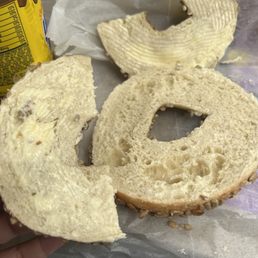 a hand holding a bagel of bagels a hand holding a bagel of bagels