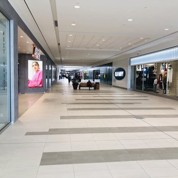 Design Flooring Centre - a woman walking through a mall - Flooring Near Me - Medicine Hat, Alberta