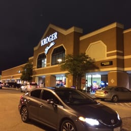 a car parked in front of a kroger store