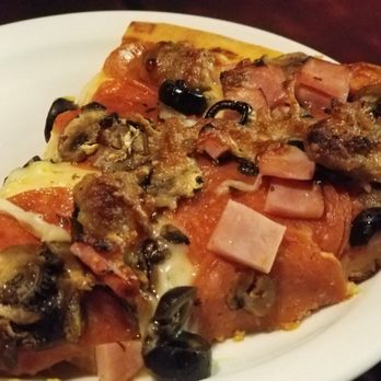 Dollies Pub & Cafe - Our amazing waitress served our first slice. - Pizza Near Me - Lahaina, Hawaii