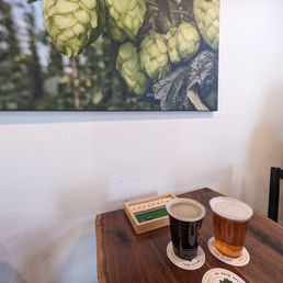 two beers on a table with coasters