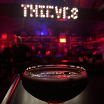 Thieves - a glass of wine sitting on a bar - Cocktail Bars Near Me - Indianapolis, Indiana