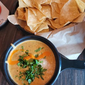 Torchy's Tacos - Green chile queso and chips - Tacos Near Me - Colorado Springs, Colorado Torchy's Tacos - Green chile queso and chips - Tacos Near Me - Colorado Springs, Colorado