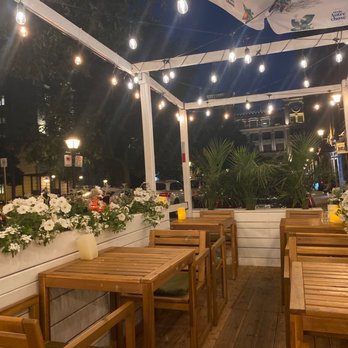 Tzatzi Qui - a patio with tables and chairs - Greek Near Me - Montreal, Quebec Tzatzi Qui - a patio with tables and chairs - Greek Near Me - Montreal, Quebec