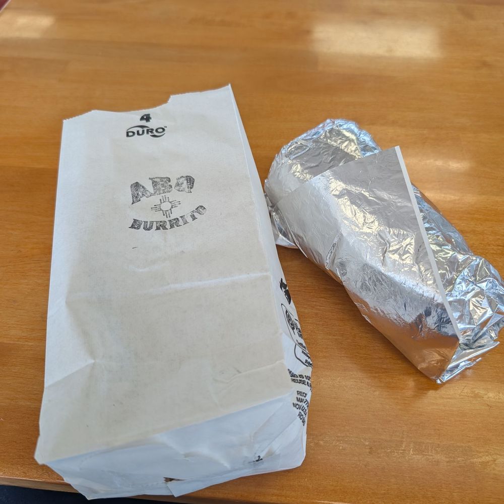 ABQ Burrito - An ABQ Burrito bag with a wrapped burrito next to it. - Mexican Near Me - Albuquerque, New Mexico