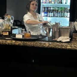 Sassy and cute- excellent bartender! Making an old fashioned drink ! Sassy and cute- excellent bartender! Making an old fashioned drink !