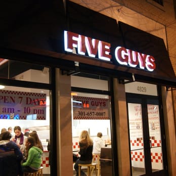 Five Guys - The Bethesda Five Guys storefront at night - Hot Dogs Near Me - Bethesda, Maryland