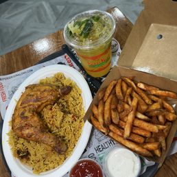 Peri peri chicken with rice, fries, and mango mojito Peri peri chicken with rice, fries, and mango mojito