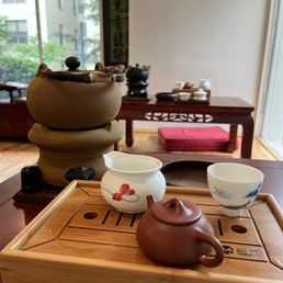a teapot and tea cups on a wooden tray a teapot and tea cups on a wooden tray