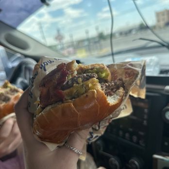 Blake's Lotaburger - a person holding a hot dog - Burgers Near Me - Bloomfield, New Mexico