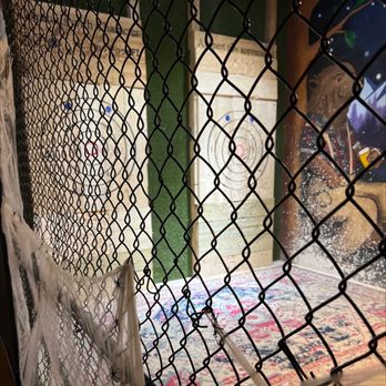 Chops + Hops Axe Throwing Lodge - through a chain link fence - Axe Throwing Near Me - Fort Lauderdale, Florida Chops + Hops Axe Throwing Lodge - through a chain link fence - Axe Throwing Near Me - Fort Lauderdale, Florida