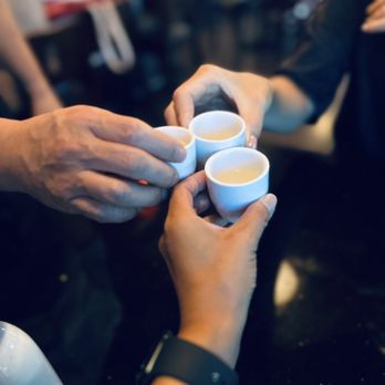 Moto Sushi - two people holding cups of coffee - Japanese Near Me - Glendale, California Moto Sushi - two people holding cups of coffee - Japanese Near Me - Glendale, California