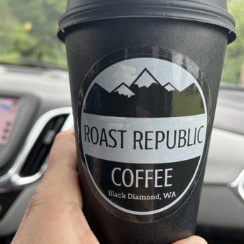 Roast Republic - a hand holding a cup of coffee - Coffee & Tea Near Me - Black Diamond, Washington Roast Republic - a hand holding a cup of coffee - Coffee & Tea Near Me - Black Diamond, Washington