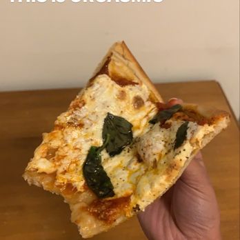 Romano Pizza - a hand holding a slice of pizza - Italian Near Me - Weehawken, New Jersey Romano Pizza - a hand holding a slice of pizza - Italian Near Me - Weehawken, New Jersey