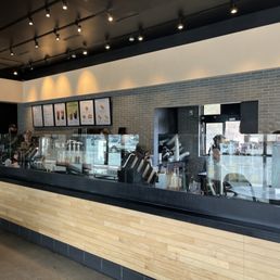 a coffee shop with a large counter a coffee shop with a large counter