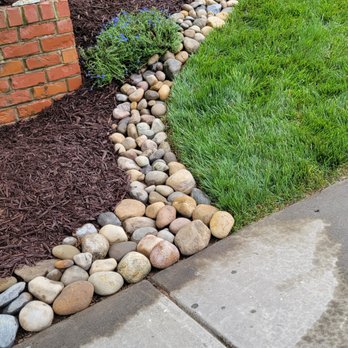 German Lawn Care and Services - a garden with rocks and grass - Lawn Services Near Me German Lawn Care and Services - a garden with rocks and grass - Lawn Services Near Me
