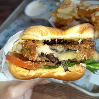 Shake Shack Encore Boston Harbor - a hand holding a sandwich - Burgers Near Me - Everett, Massachusetts