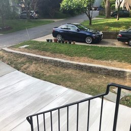 After with a new driveway and stone retaining wall to reroute the water flow.