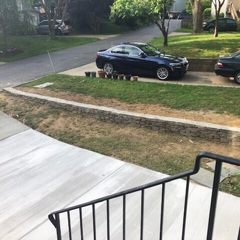 Green Lady Masonry and Drainage Solutions - After with a new driveway and stone retaining wall to reroute the water flow. - Masonry/Concrete Near Me