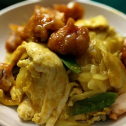 New China Restaurant - Three favorites, one bowl. General Tso's Chicken and Curry Chicken on top of Young Chow Fried Rice!