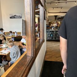 Crosscut Pizzeria and Taphouse - Line to get in with glassed in dining rooms on both sides