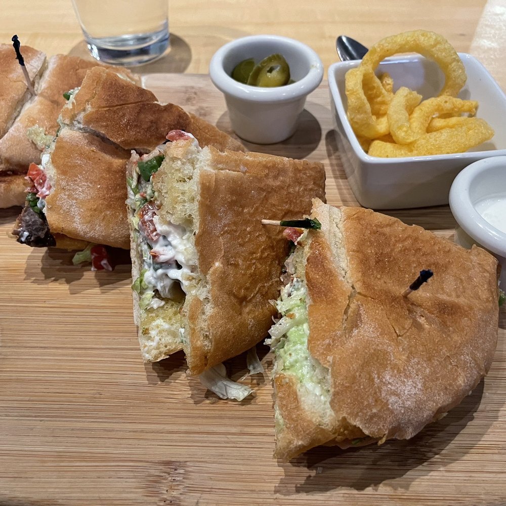 a cut in half sandwich and french fries