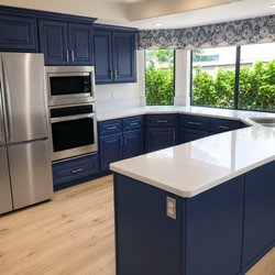 Pacific Kitchens Inc - Refaced with maple in "Blue Heron" by Benjamin Moore plus new Quartz countertops.