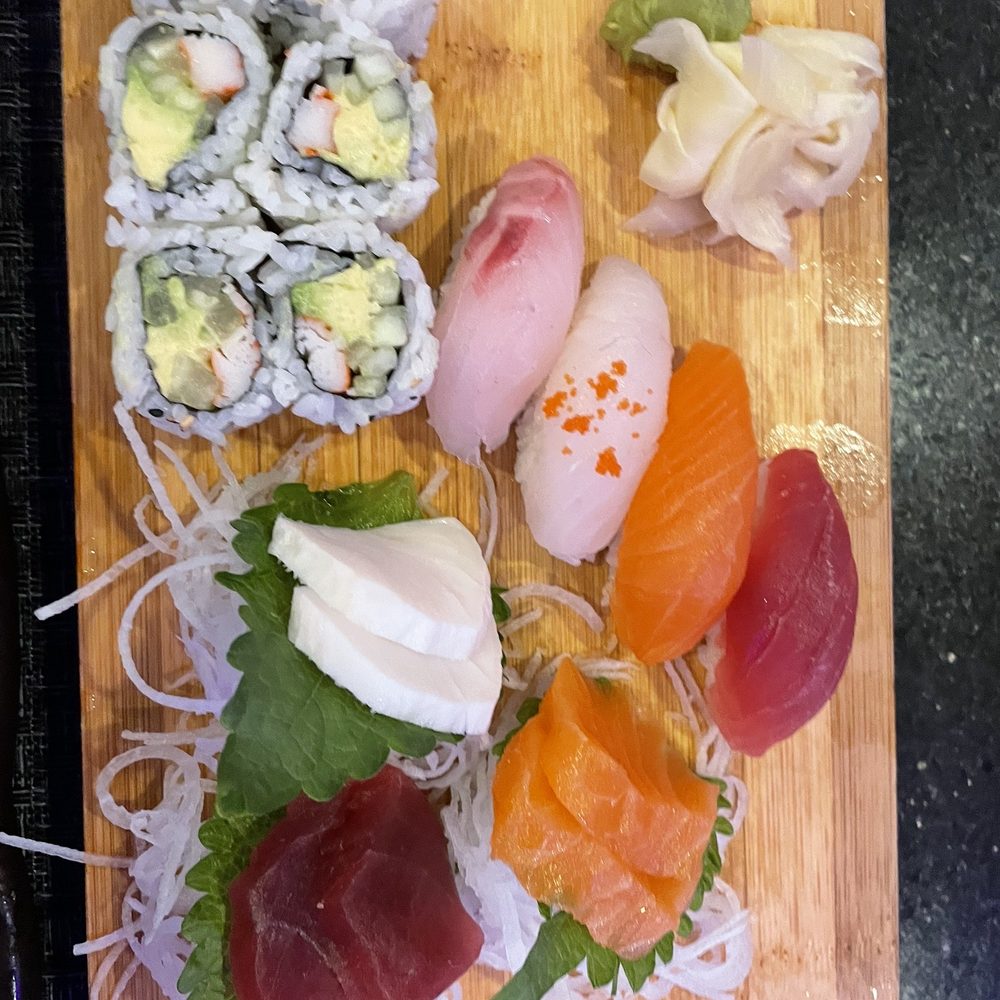 a variety of sushi on a wooden board a variety of sushi on a wooden board