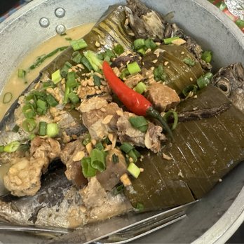 Barrio Fiesta - Tulingan (bullet tuna) gata sardines-style (bones are soft enough to eat!) in banana leaves - Filipino Near Me - Calgary, Alberta Barrio Fiesta - Tulingan (bullet tuna) gata sardines-style (bones are soft enough to eat!) in banana leaves - Filipino Near Me - Calgary, Alberta