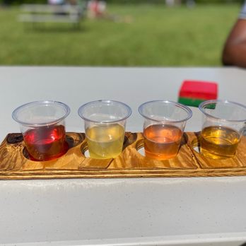 Doc Waters Cidery - four glasses of cid on a wooden tray - Cideries Near Me - Germantown, Maryland Doc Waters Cidery - four glasses of cid on a wooden tray - Cideries Near Me - Germantown, Maryland