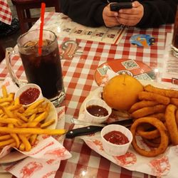 Brisket sandwich with fries and onion rings