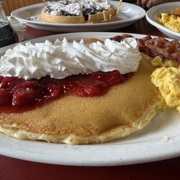 Waffle with blueberries and pancakes with strawberries. Waffle with blueberries and pancakes with strawberries.