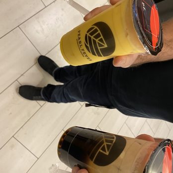 Pearl Fever Tea House - a person holding two cups of tea - Coffee & Tea Near Me - Surrey, British Columbia Pearl Fever Tea House - a person holding two cups of tea - Coffee & Tea Near Me - Surrey, British Columbia
