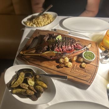 Malio's Beach House - Tomahawk and fingerling potatoes and smoked Gouda Mac and cheese - Seafood Near Me - St. Pete Beach, Florida Malio's Beach House - Tomahawk and fingerling potatoes and smoked Gouda Mac and cheese - Seafood Near Me - St. Pete Beach, Florida