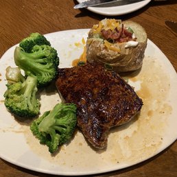 Outback Center-Cut Sirloin with broccoli and a loaded baked potato.