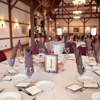 Concorde Centre - Photo by Brianne Bradbury Photography - the Inside of the barn/banquet room.  There is a fireplace behind the photog. - Venues & Event Spaces Near Me - Woodstock, Illinois