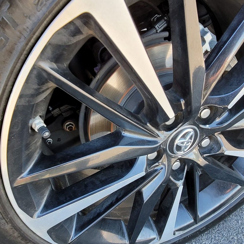 a close up of a tire on a car a close up of a tire on a car