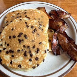 Chocolate chip pancakes and a generous side of bacon.