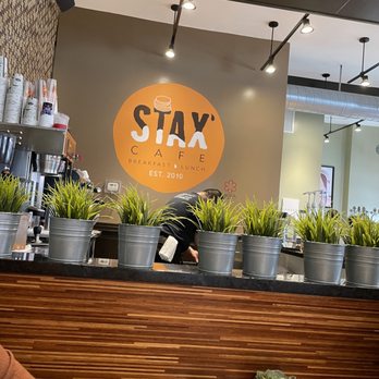 Stax Cafe - a person sitting at a table with plants on the counter - Breakfast & Brunch Near Me - Chicago, Illinois